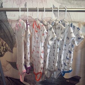 Set of 7 hard to find /retired print 12-18 month Kyte short sleeve bodysuits.